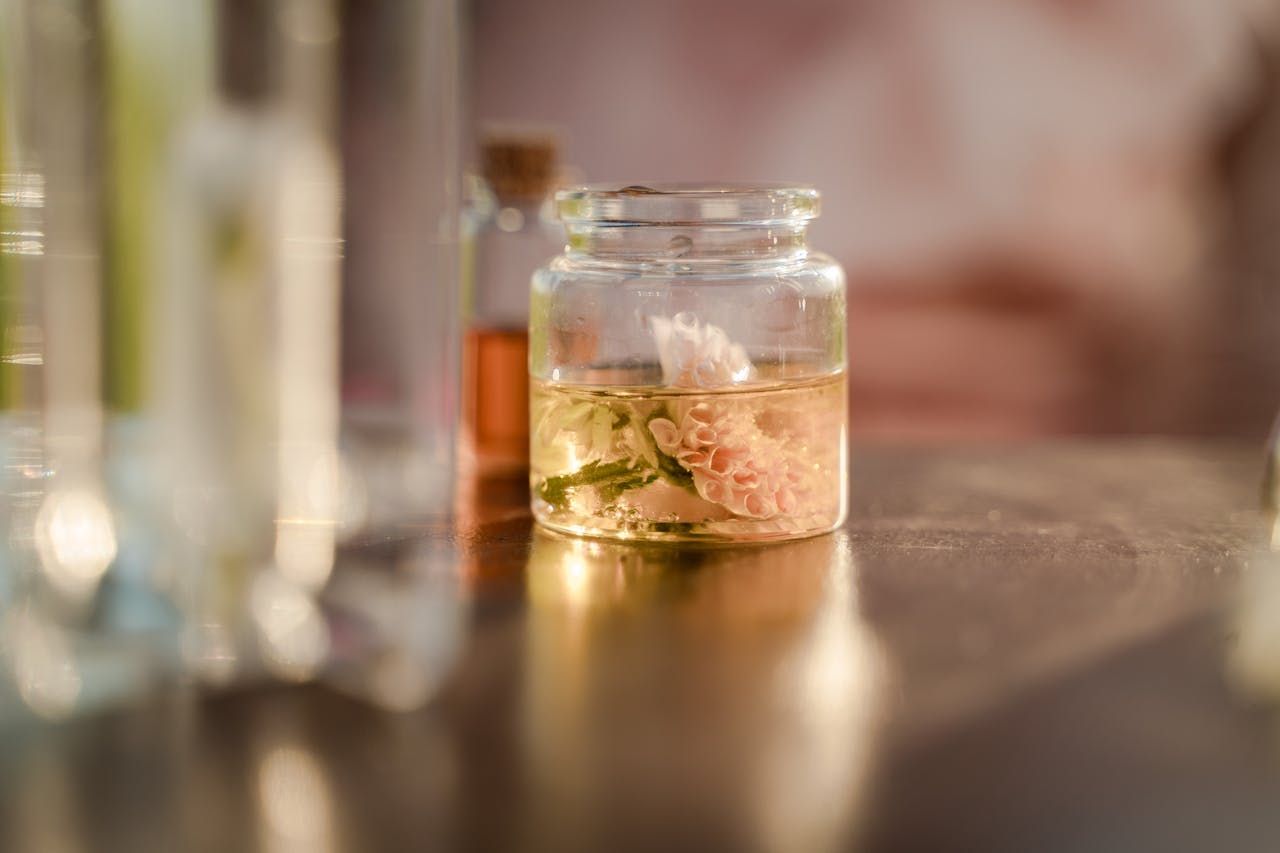 team-01 Close-up of a delicate flower submerged in a glass jar filled with liquid, on a table.